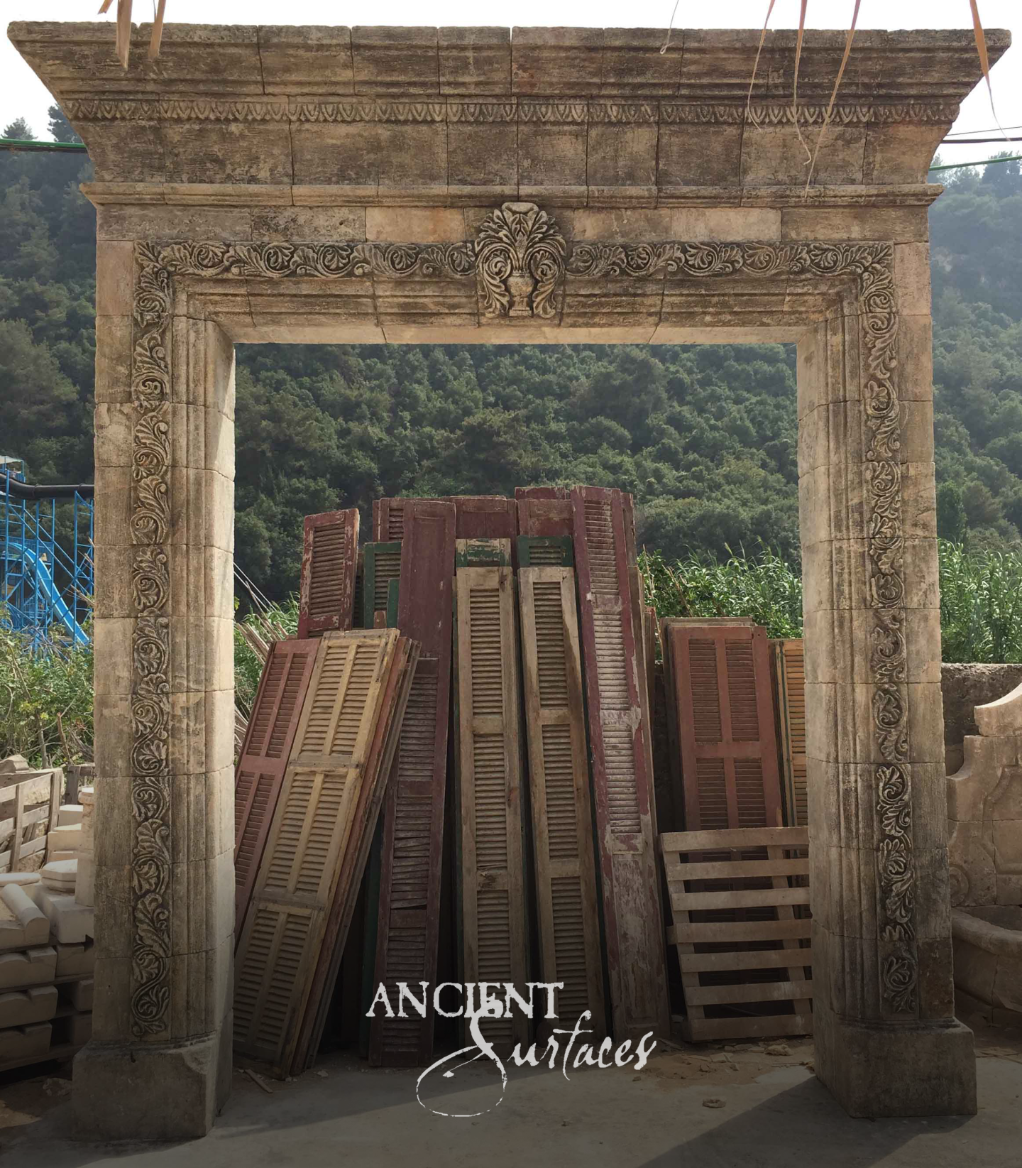 Reclaimed antique limestone arch carved as a grand entrance, hand-finished and weathered
