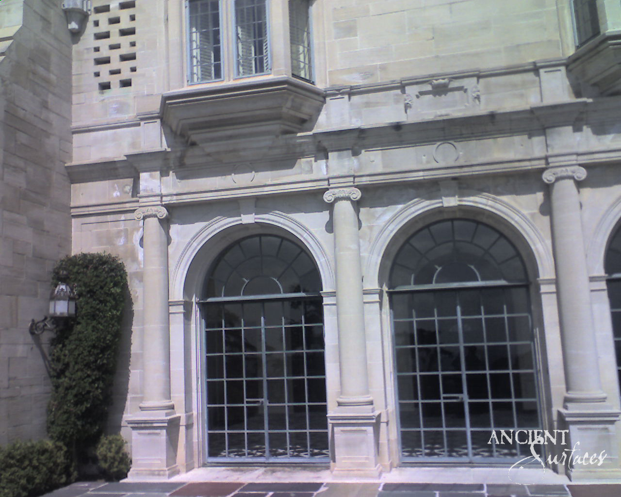 Antique reclaimed limestone arch showing its natural patina and hand-carved detailing