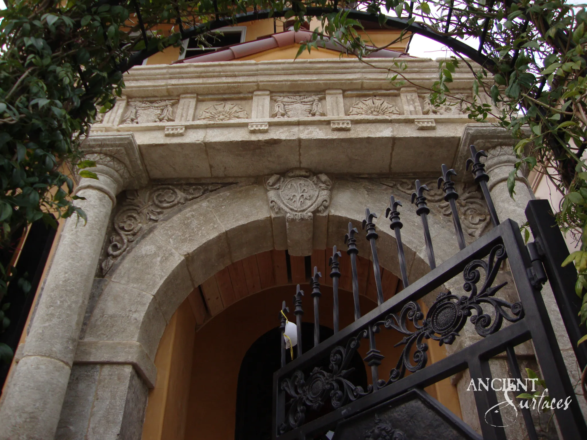 Antique reclaimed limestone arch presented edge to edge as an architectural feature