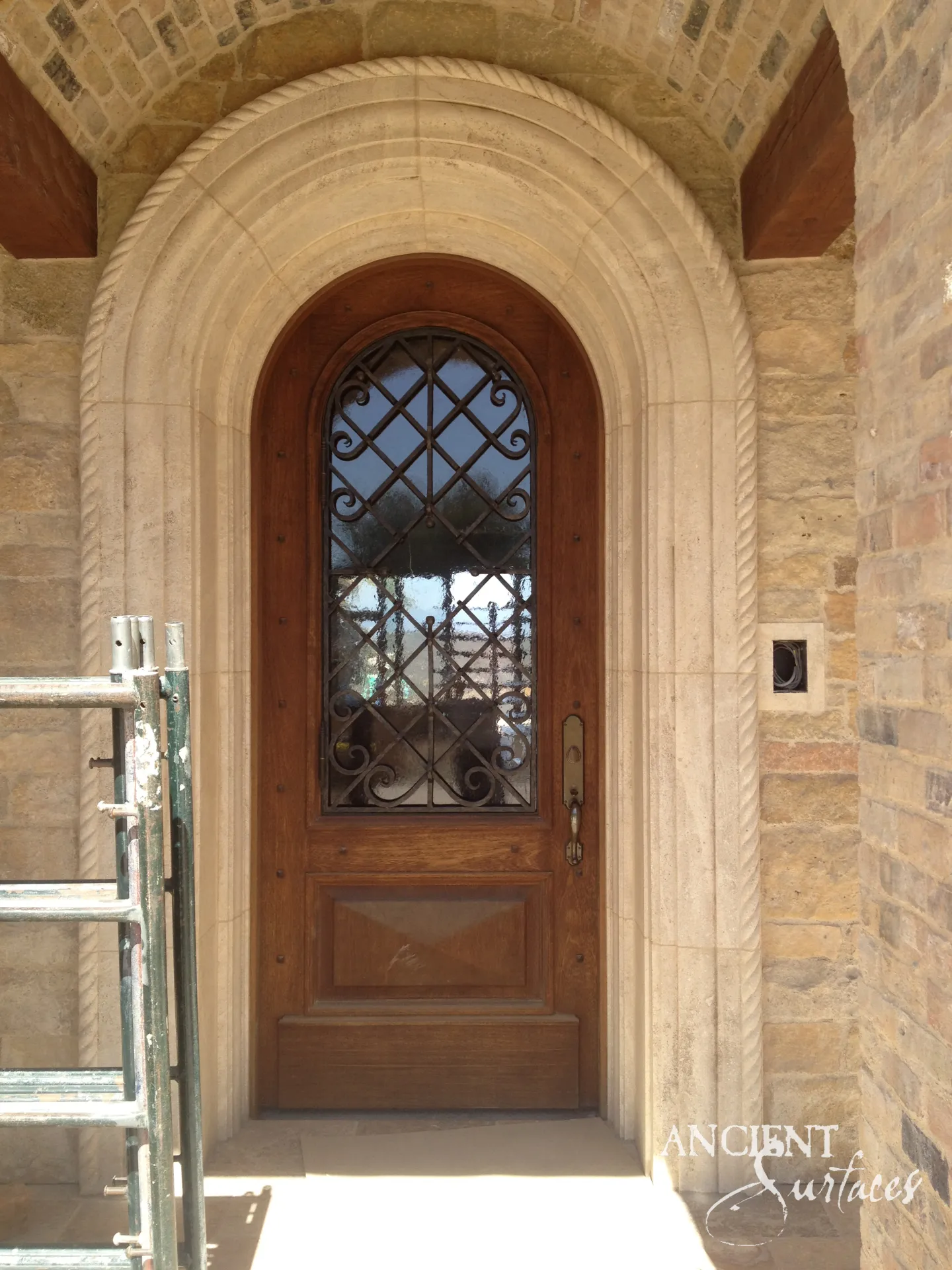 Hand-carved reclaimed limestone arch with softened edges and natural patina